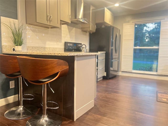 3629 Embry Cir, Atlanta, GA 30341 - kitchen with dark wood-style flooring, tasteful backsplash, light stone countertops, and freestanding refrigerator