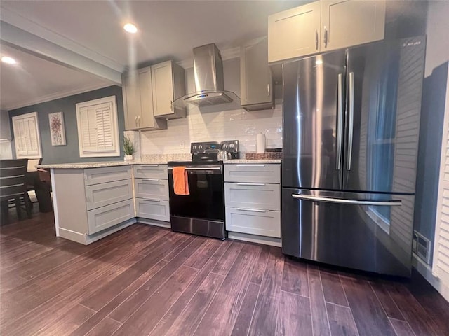 3629 Embry Cir, Atlanta, GA 30341 - kitchen featuring wall chimney range hood, black electric range, dark wood finished floors, a peninsula, and freestanding refrigerator