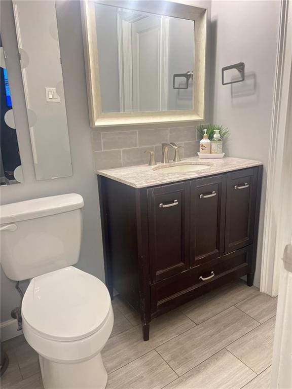 3629 Embry Cir, Atlanta, GA 30341 - bathroom featuring toilet, tasteful backsplash, vanity, and wood finished floors