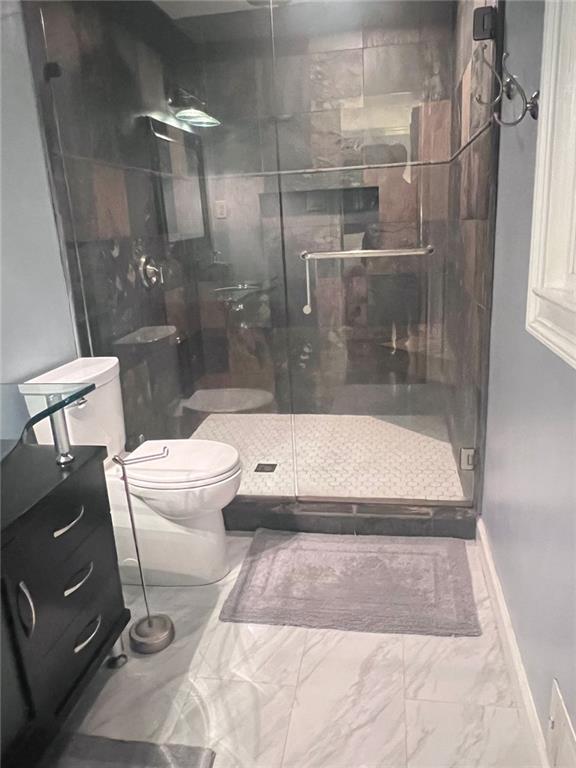 3629 Embry Cir, Atlanta, GA 30341 - full bath with marble finish floor, baseboards, a stall shower, and toilet