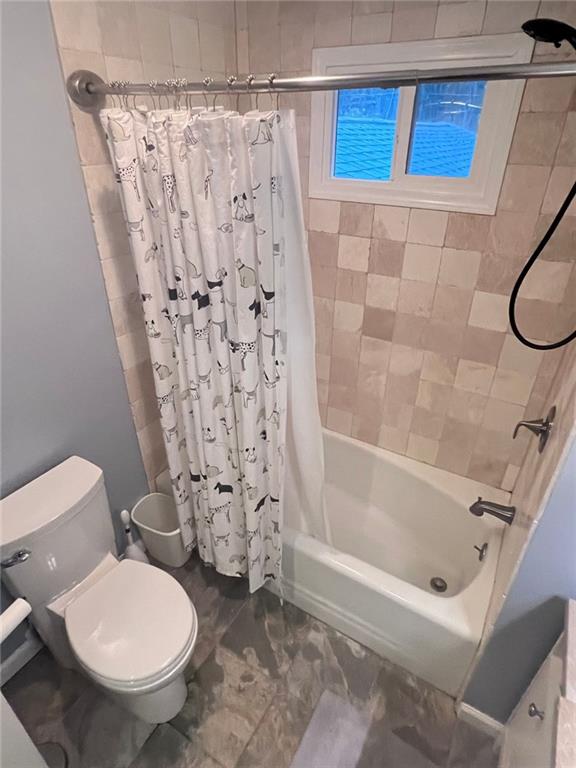 3629 Embry Cir, Atlanta, GA 30341 - bathroom featuring toilet and shower / bath combination with curtain
