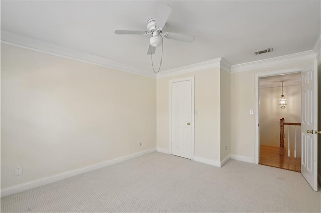 unfurnished bedroom featuring ceiling fan, crown molding, and light carpet