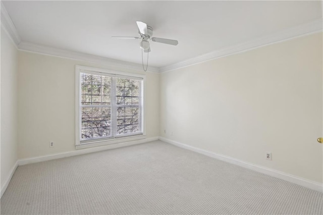 carpeted spare room featuring ceiling fan and ornamental molding