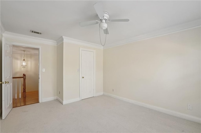 unfurnished bedroom with ornamental molding, light colored carpet, and ceiling fan