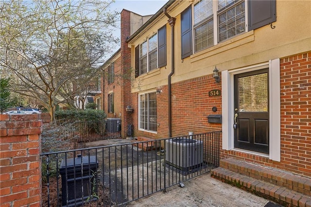 entrance to property featuring a patio area and central air condition unit