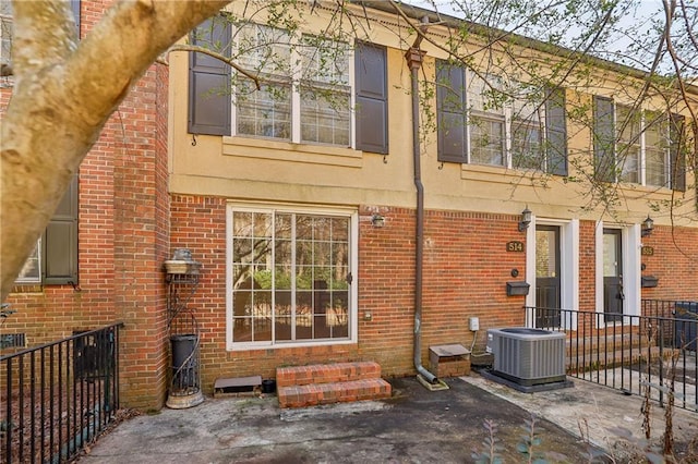 rear view of house with cooling unit and a patio