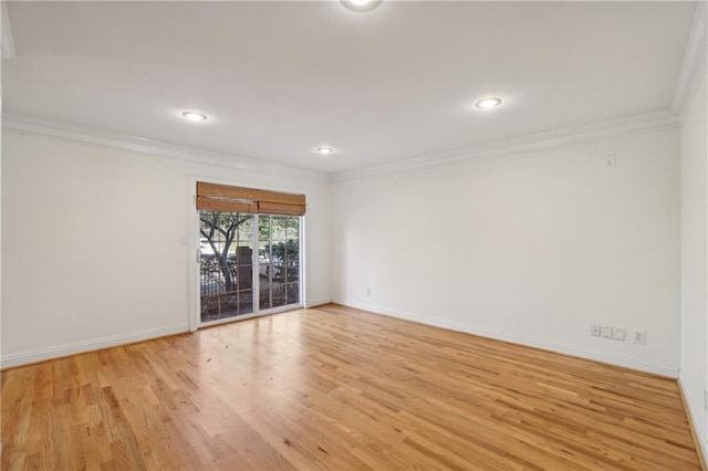 unfurnished room featuring light wood-type flooring and crown molding