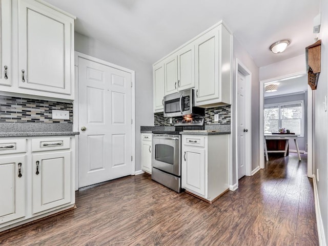 kitchen with stainless steel appliances, decorative backsplash, dark wood-style floors, and white cabinetry