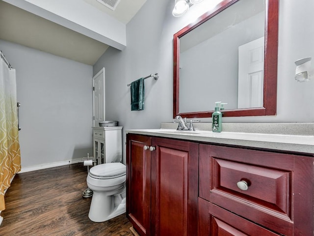 full bath with toilet, wood finished floors, vanity, and baseboards