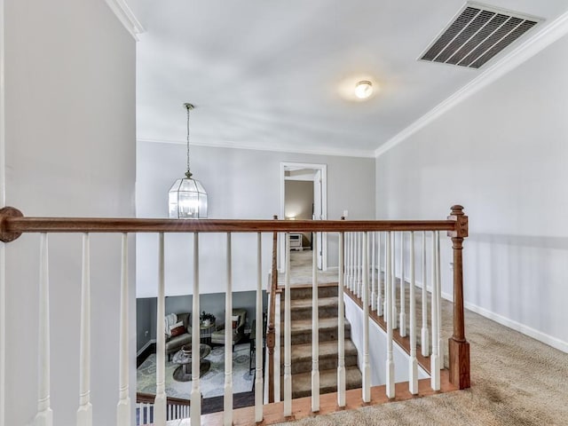 stairs featuring crown molding, carpet, and baseboards