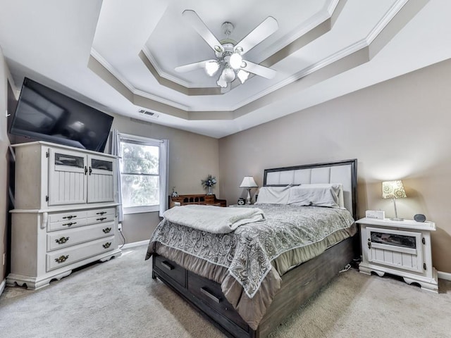 bedroom featuring crown molding, a raised ceiling, light carpet, baseboards, and a ceiling fan