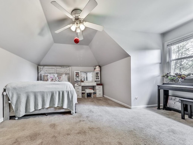 carpeted bedroom featuring baseboards, vaulted ceiling, and a ceiling fan
