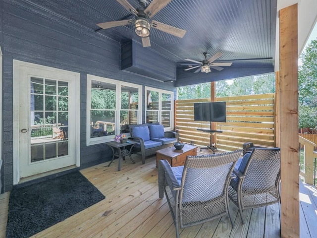 wooden terrace with an outdoor hangout area and ceiling fan