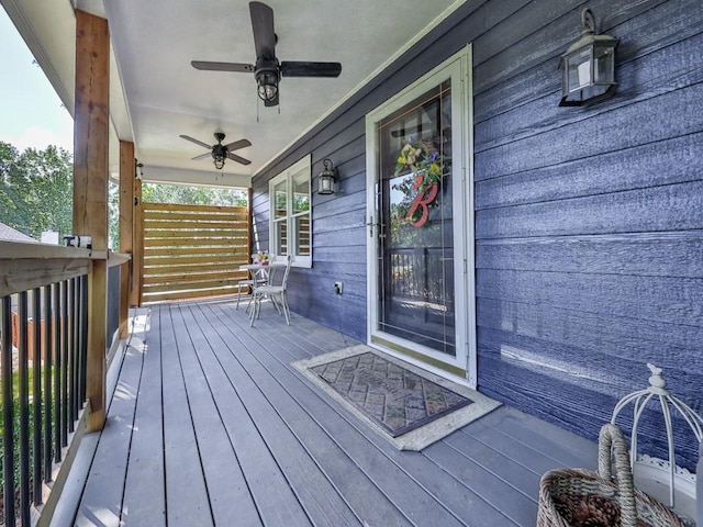 wooden deck with covered porch and ceiling fan