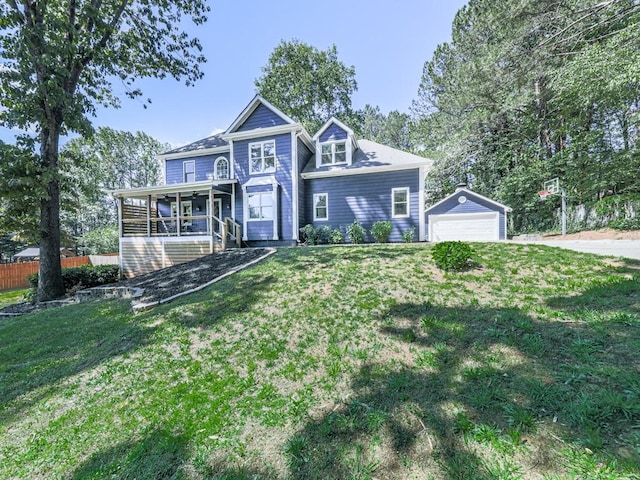 view of front of home with a detached garage, an outdoor structure, and covered porch
