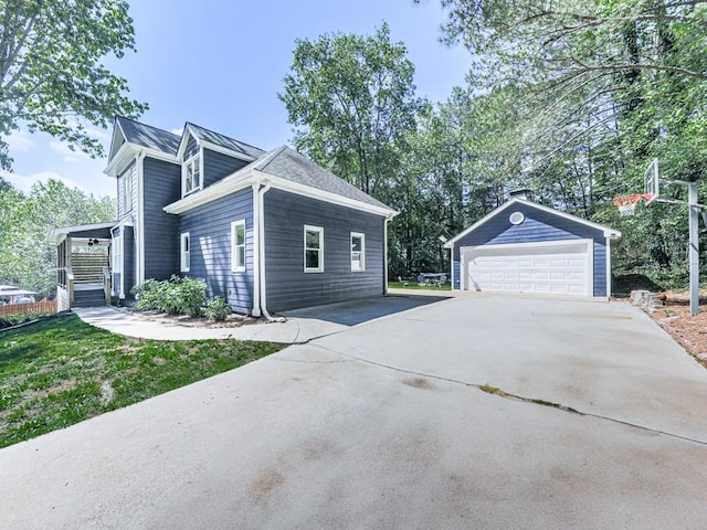 view of side of home featuring an outbuilding and a detached garage