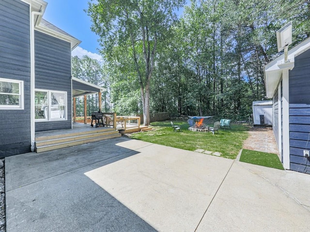 view of patio / terrace featuring a fire pit and a wooden deck