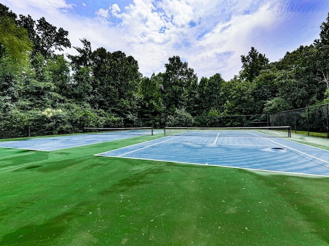 view of tennis court with fence