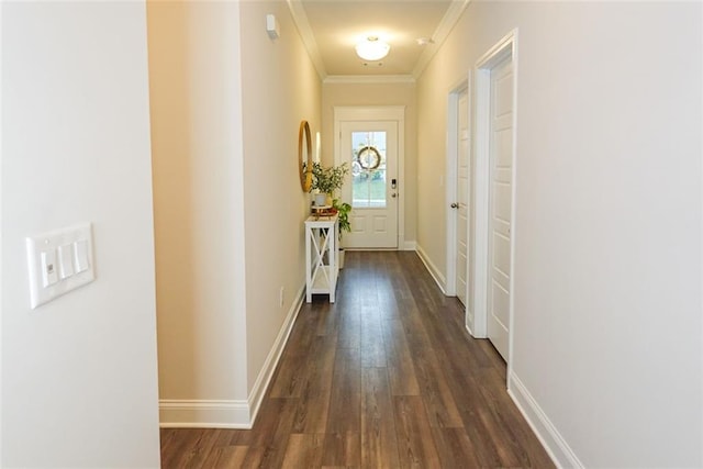 corridor with ornamental molding and dark wood-type flooring