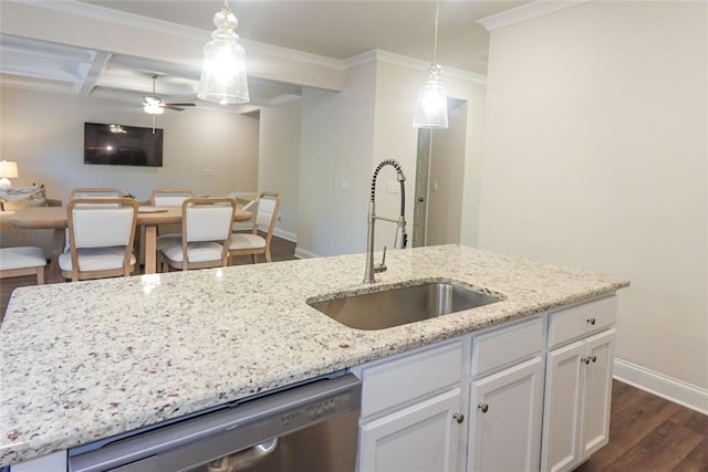 kitchen featuring pendant lighting, white cabinetry, stainless steel dishwasher, and sink