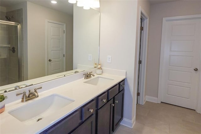 bathroom featuring tile patterned floors, vanity, and walk in shower