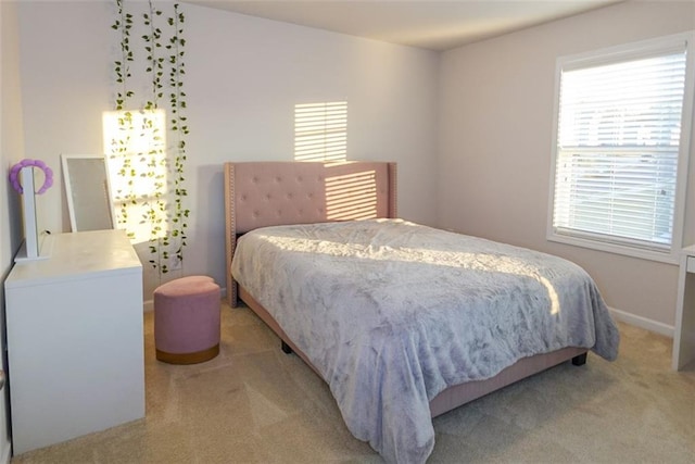 bedroom featuring carpet floors and multiple windows