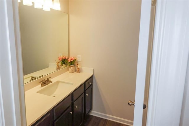 bathroom with hardwood / wood-style floors and vanity