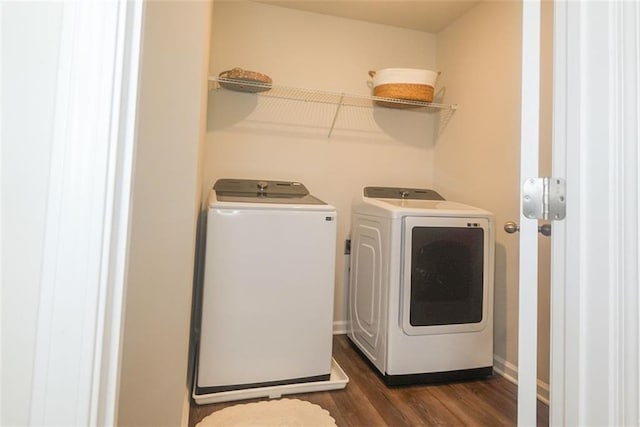 laundry area with dark hardwood / wood-style flooring and washing machine and clothes dryer