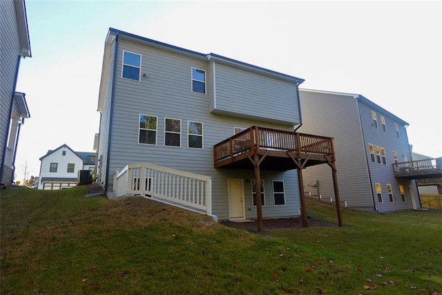 rear view of house featuring central AC unit, a deck, and a yard