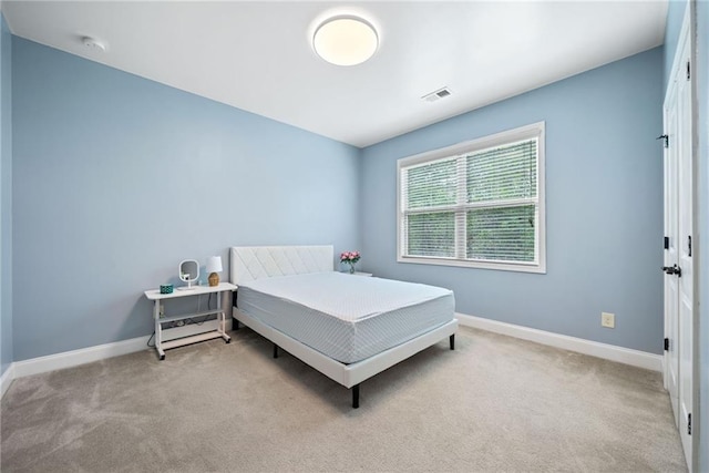 bedroom featuring baseboards, carpet, and visible vents