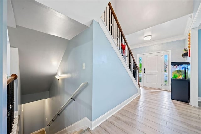 stairway with wood finished floors and baseboards