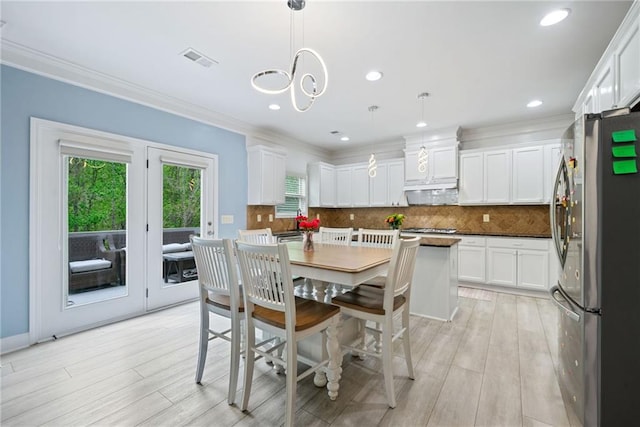 dining area featuring ornamental molding, visible vents, recessed lighting, and light wood-style floors