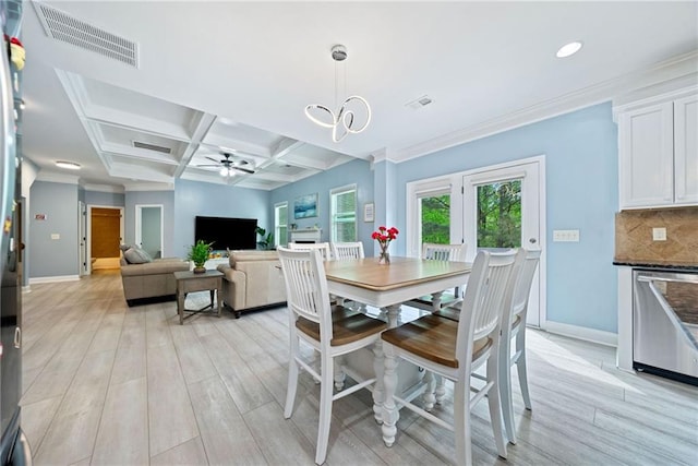 dining space with visible vents, ceiling fan with notable chandelier, baseboards, and light wood-style flooring