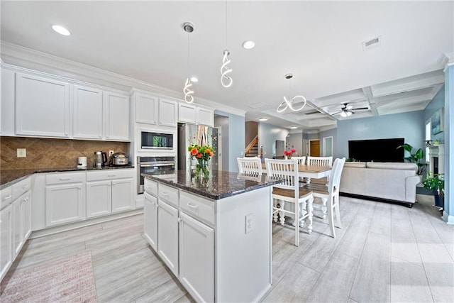 kitchen with visible vents, ceiling fan, appliances with stainless steel finishes, and light wood-type flooring