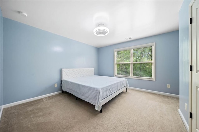 bedroom featuring carpet flooring, visible vents, and baseboards