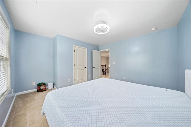 carpeted bedroom with baseboards