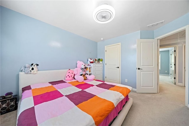 carpeted bedroom featuring baseboards and visible vents