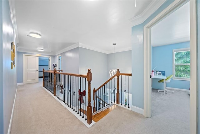 corridor featuring carpet flooring, baseboards, ornamental molding, and an upstairs landing