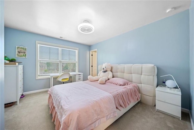 bedroom with visible vents, baseboards, and light carpet