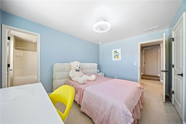 bedroom with visible vents and light carpet