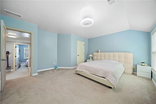 bedroom with visible vents, baseboards, carpet flooring, and vaulted ceiling
