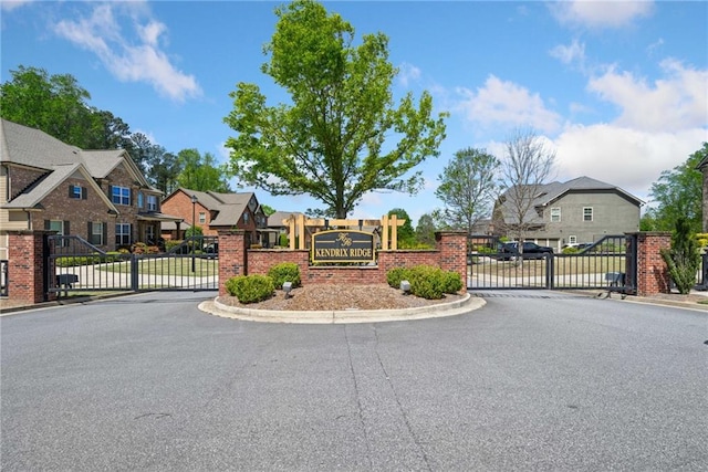 view of street with a gated entry, a residential view, and a gate