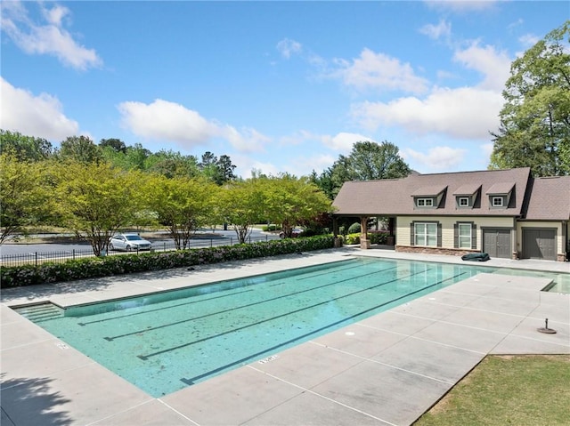 view of swimming pool with fence, a fenced in pool, and a patio