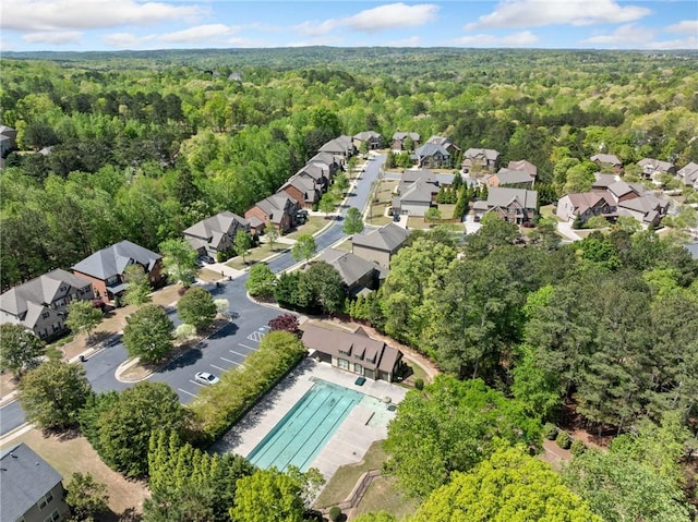 birds eye view of property featuring a forest view and a residential view