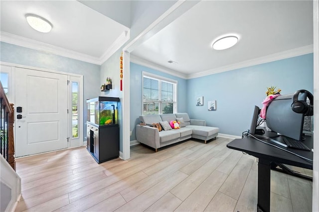living room featuring visible vents, ornamental molding, light wood-style flooring, and baseboards