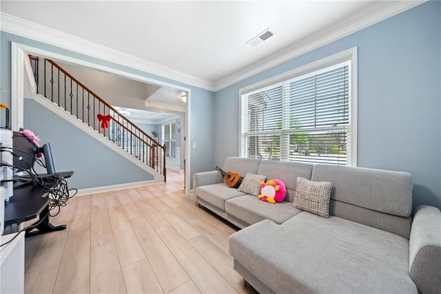 living area with crown molding, visible vents, wood finished floors, stairs, and baseboards