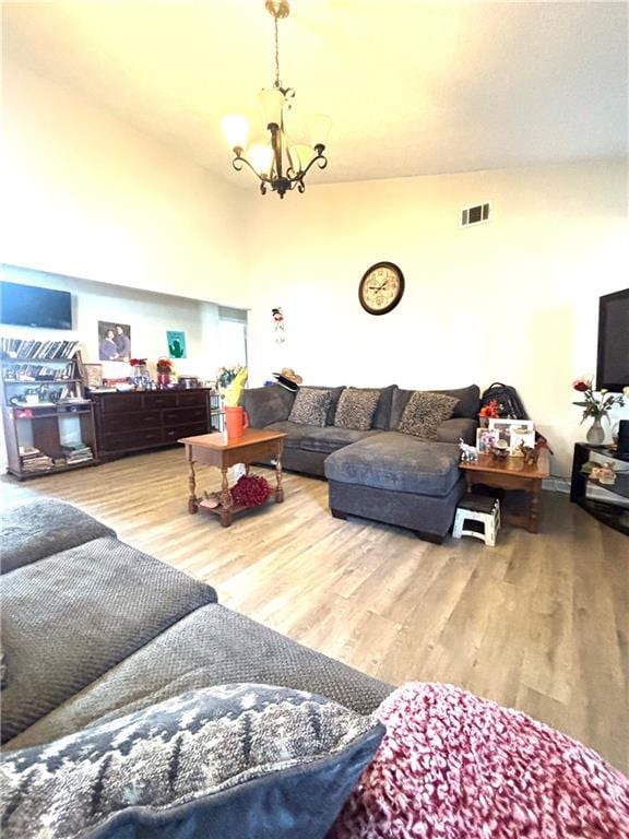 5687 Pine Meadow Ct, Morrow, GA 30260 - living room with vaulted ceiling, visible vents, a chandelier, and wood finished floors
