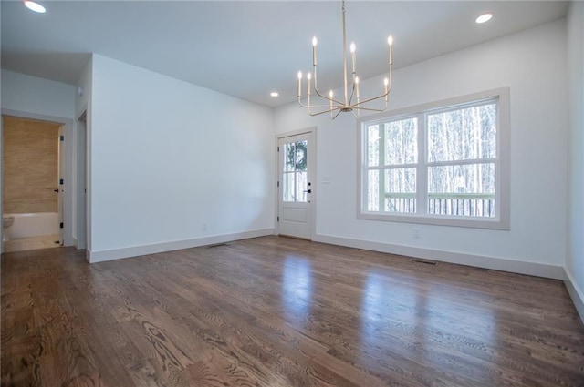 interior space with dark wood-style floors, baseboards, and a chandelier