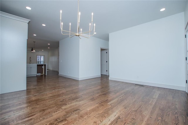 empty room with recessed lighting, a sink, and wood finished floors