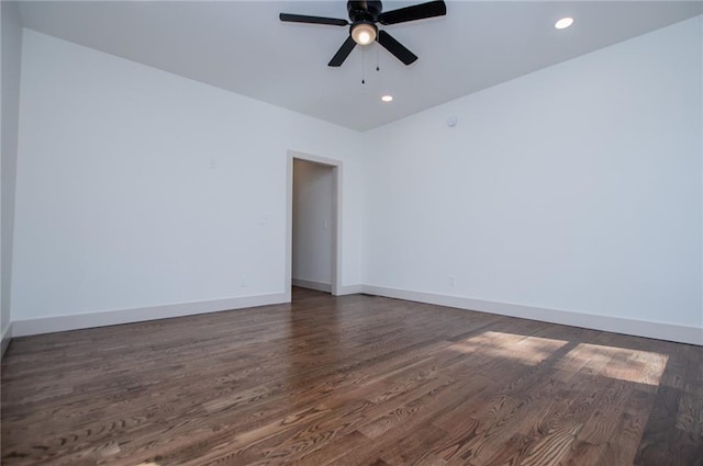 spare room with dark wood-style floors, recessed lighting, baseboards, and a ceiling fan